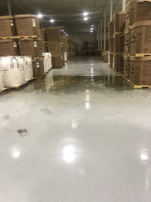 Interior view of warehouse with a large amount of water on the floor.
